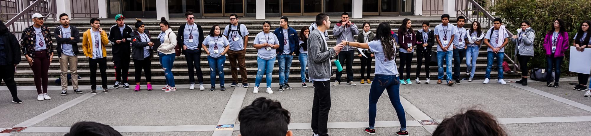 Image of participants in a circle during a youth conference event